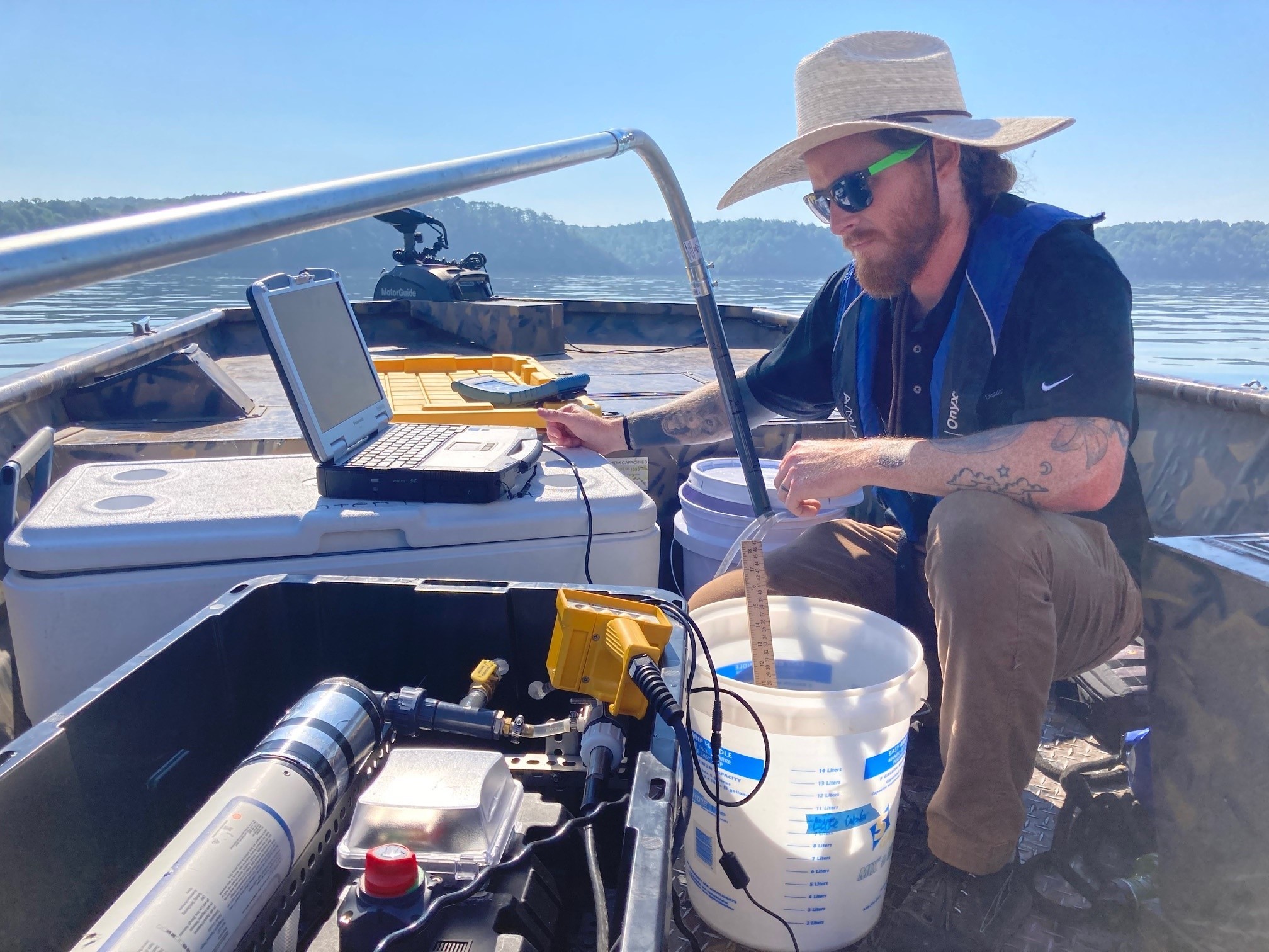 Beaver Water District staff on a boat on Beaver Lake taking measurements of water