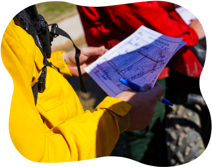 Person in yellow coat holding a map of Beaver Lake's source water