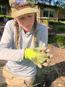 Arkansas Conservation Corps volunteer holding a frog